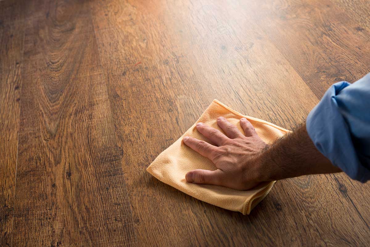 A person cleaning hardwood floor